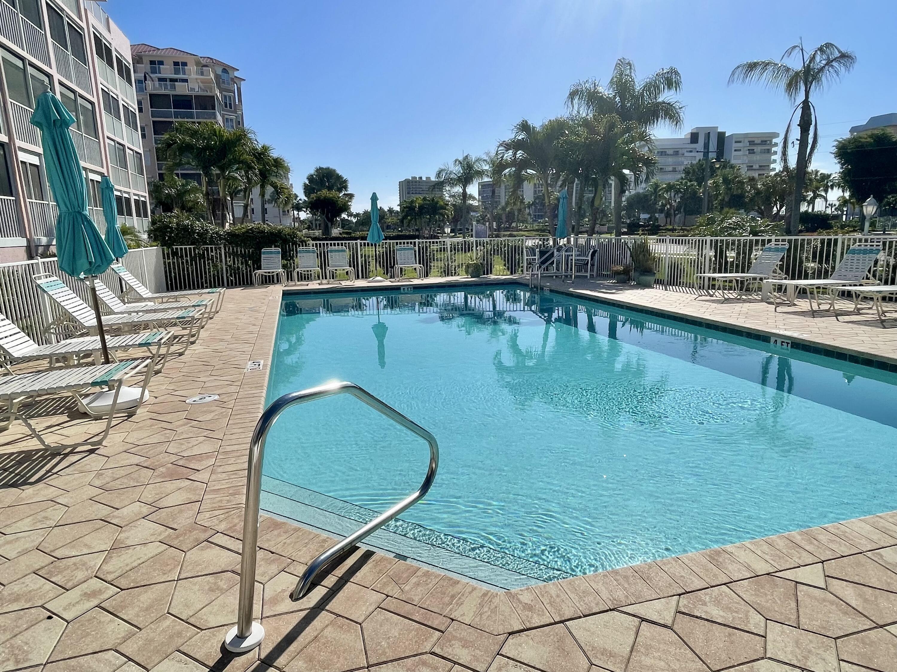 960 Huron Street, Unit 106 Marco Island, FL 34145 - Photo 28 of 39 a swimming pool with outdoor seating and yard