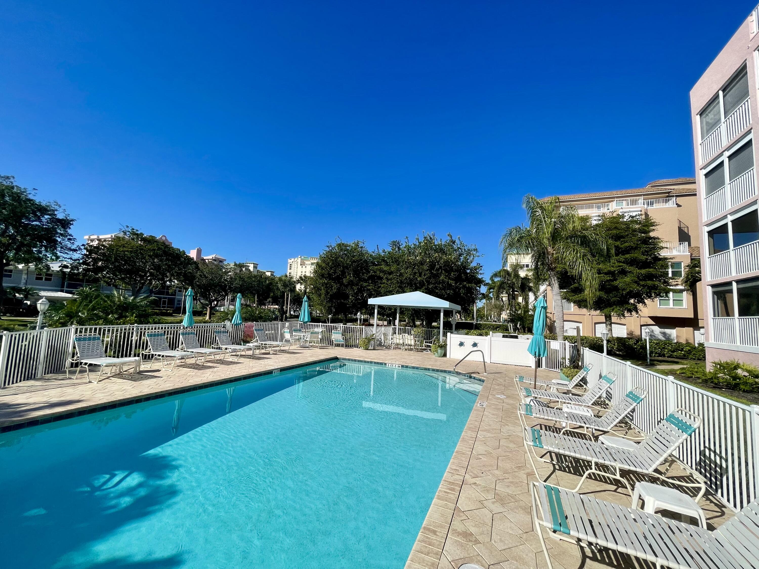 960 Huron Street, Unit 106 Marco Island, FL 34145 - Photo 29 of 39 a view of a swimming pool with lounge chairs