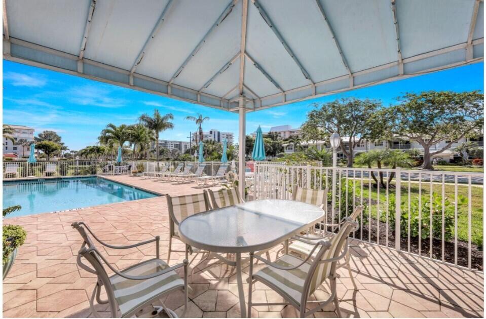 960 Huron Street, Unit 106 Marco Island, FL 34145 - Photo 30 of 39 a patio with water view fountain and a table