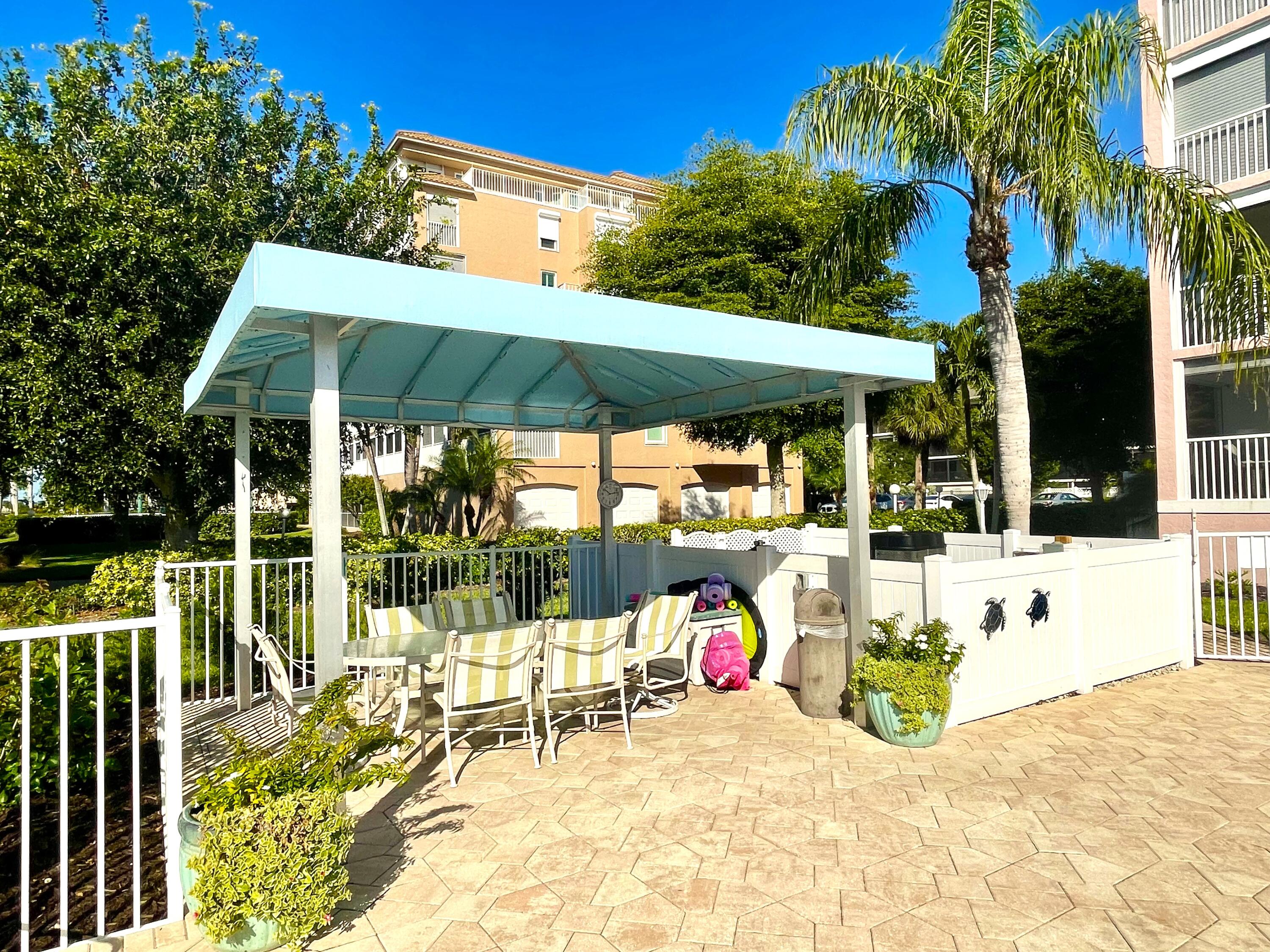 960 Huron Street, Unit 106 Marco Island, FL 34145 - Photo 31 of 39 a view of a chair and tables in the patio