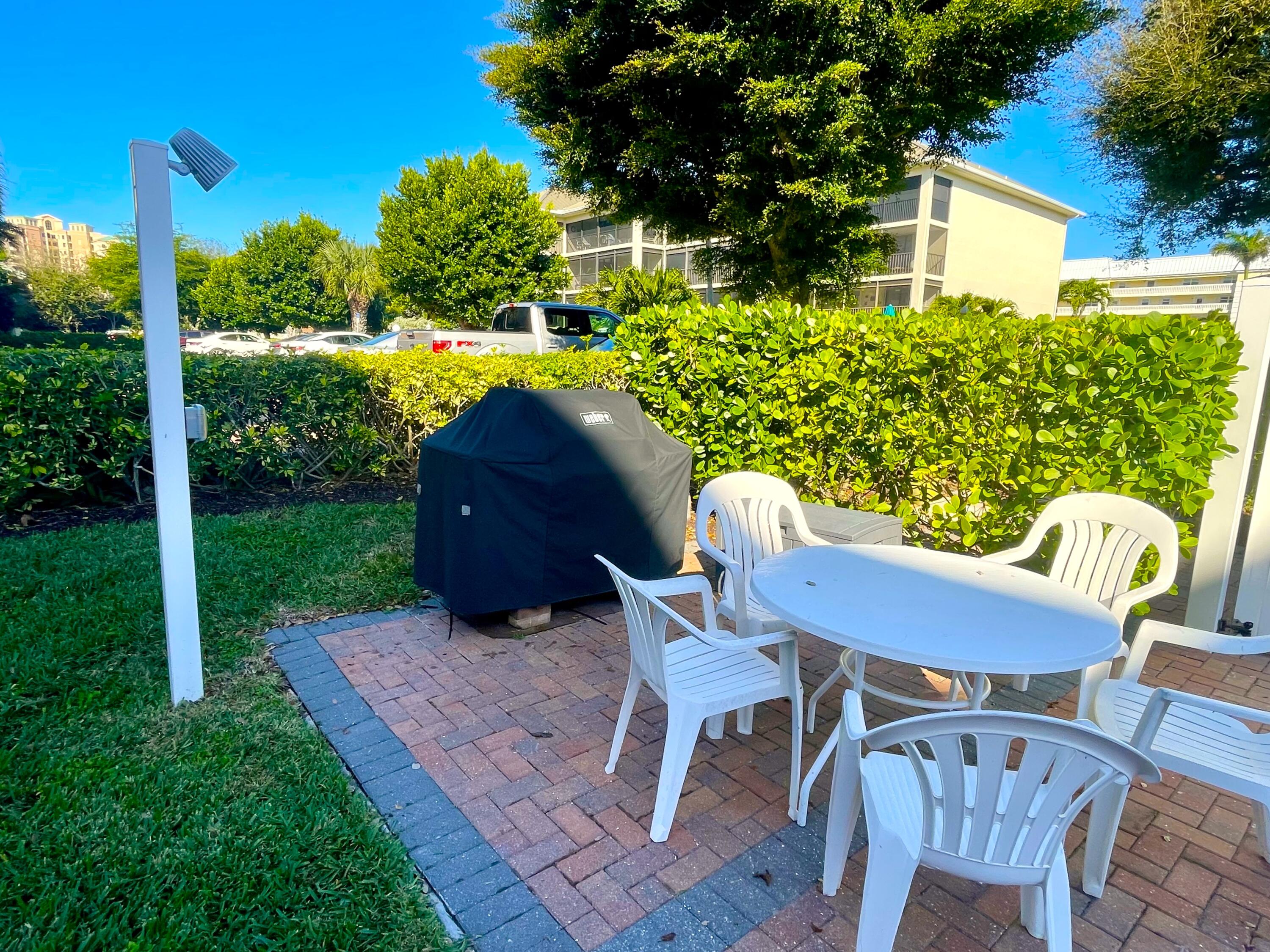 960 Huron Street, Unit 106 Marco Island, FL 34145 - Photo 32 of 39 a view of a chair and table in backyard of the house