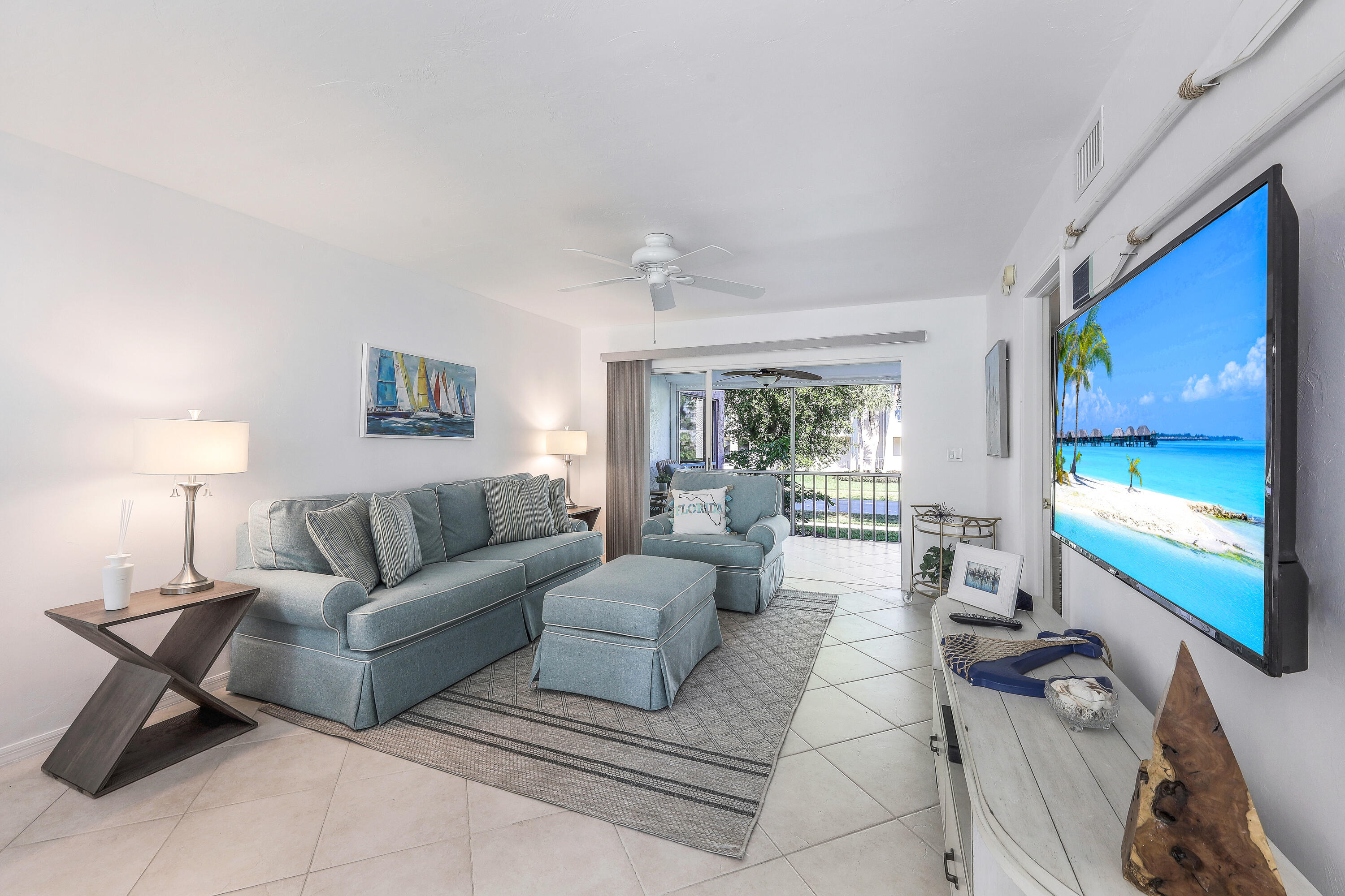 960 Huron Street, Unit 106 Marco Island, FL 34145 - Photo 4 of 39 a living room with furniture and a flat screen tv
