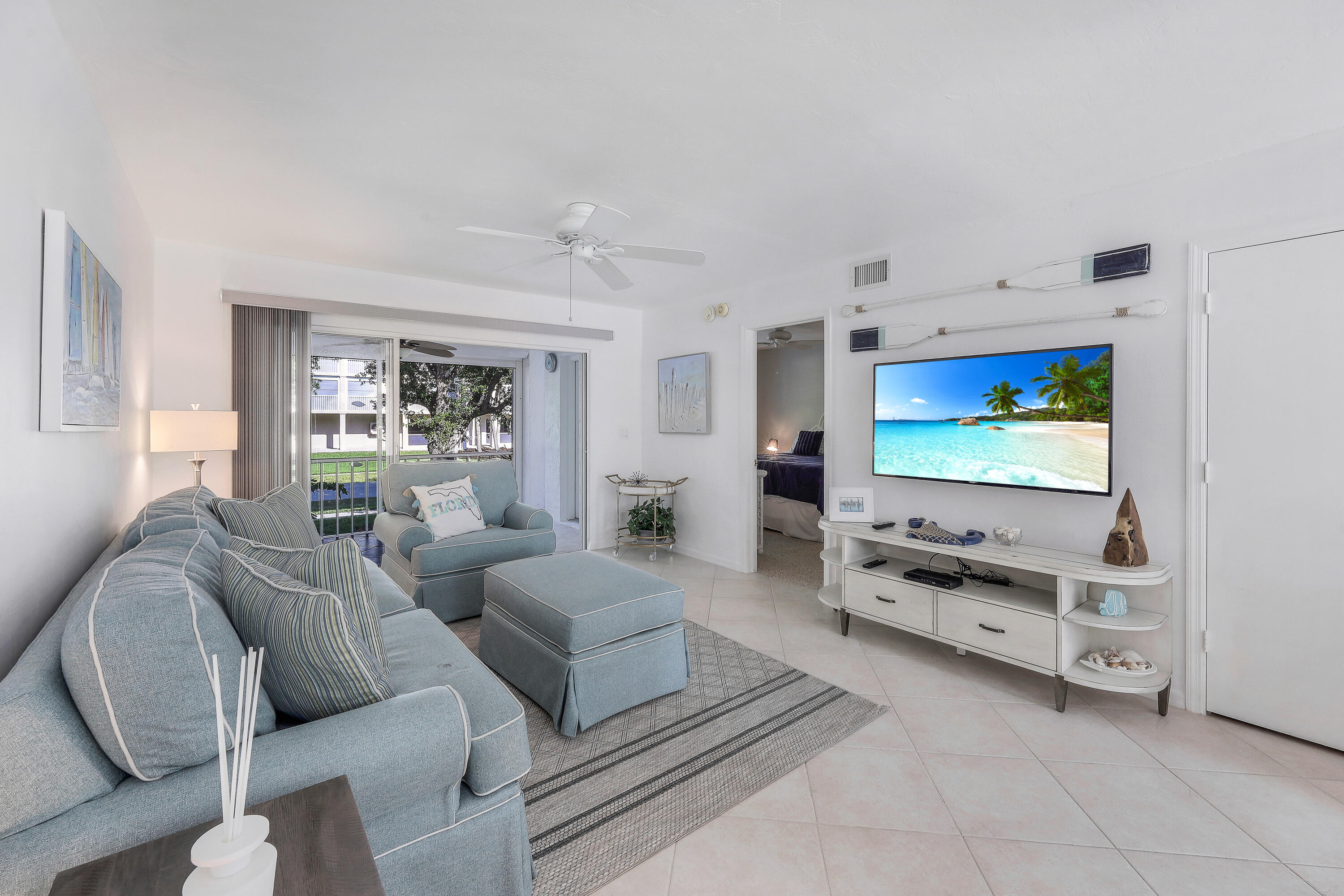 960 Huron Street, Unit 106 Marco Island, FL 34145 - Photo 5 of 39 a living room with furniture and a flat screen tv