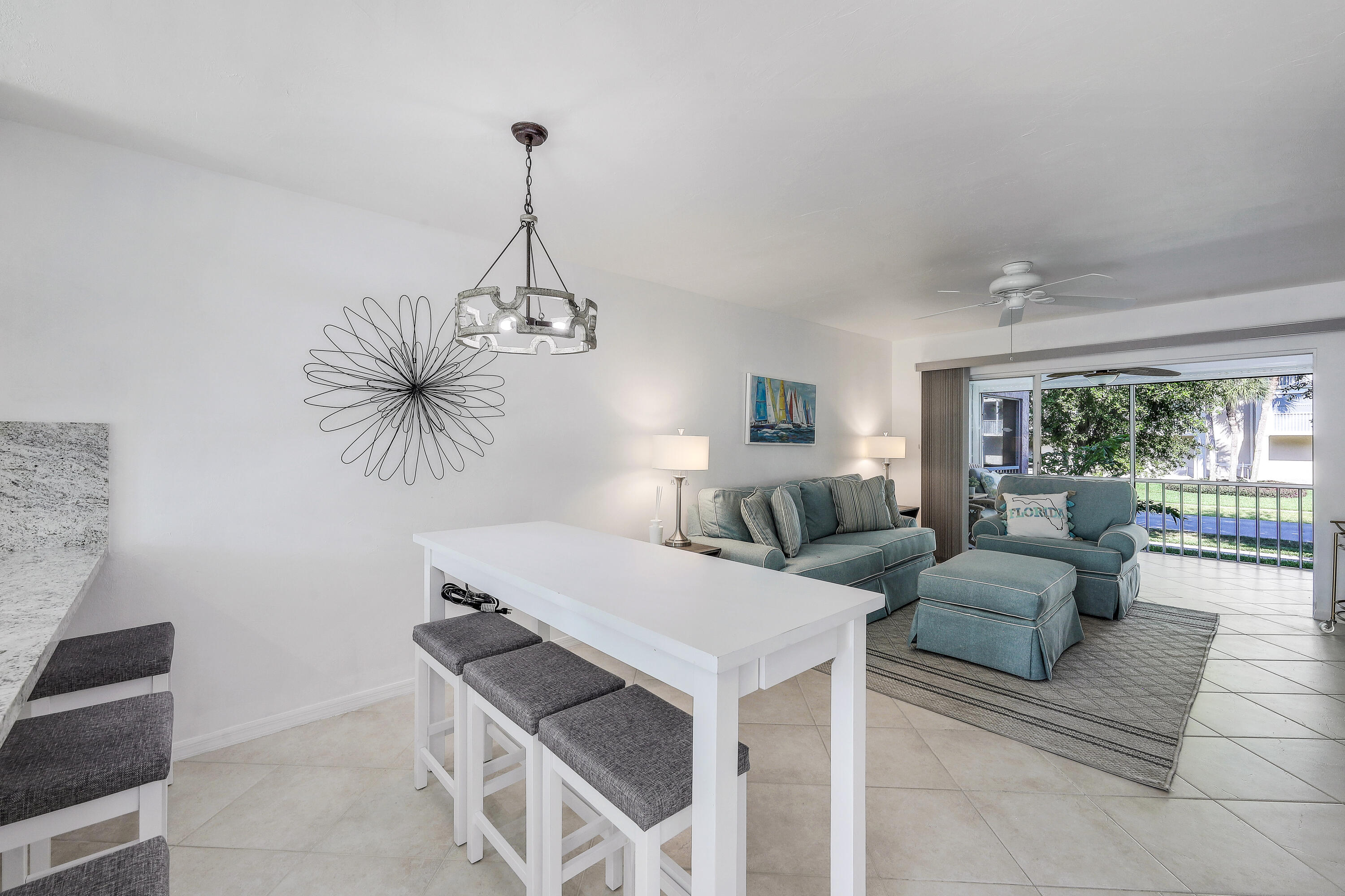 960 Huron Street, Unit 106 Marco Island, FL 34145 - Photo 7 of 39 a living room with furniture and a chandelier
