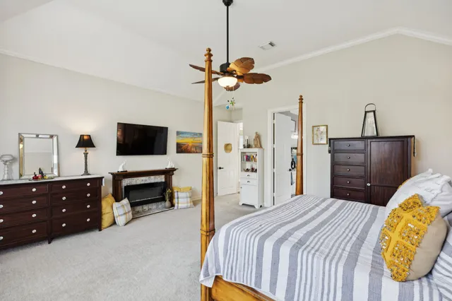 a bedroom with a bed a dresser and flat screen tv