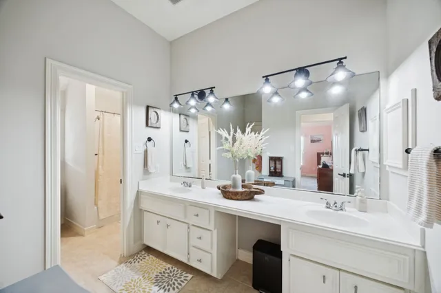 a bathroom with a double vanity sink mirror and double