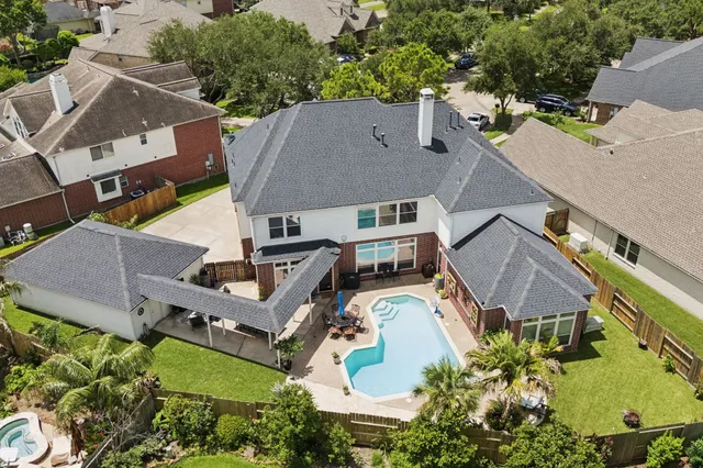 an aerial view of residential houses with outdoor space