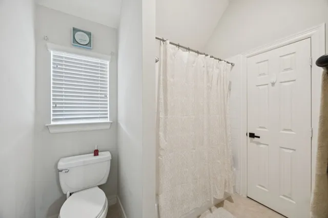 a bathroom with a toilet a sink and a mirror