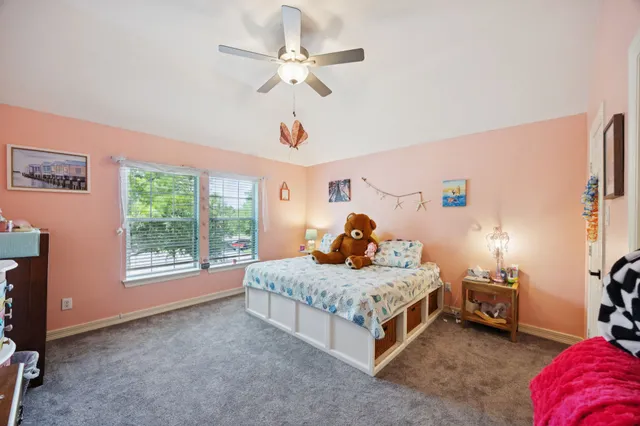 a bedroom with a bed a window and a chandelier