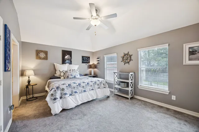 a bedroom with bed and a chandelier