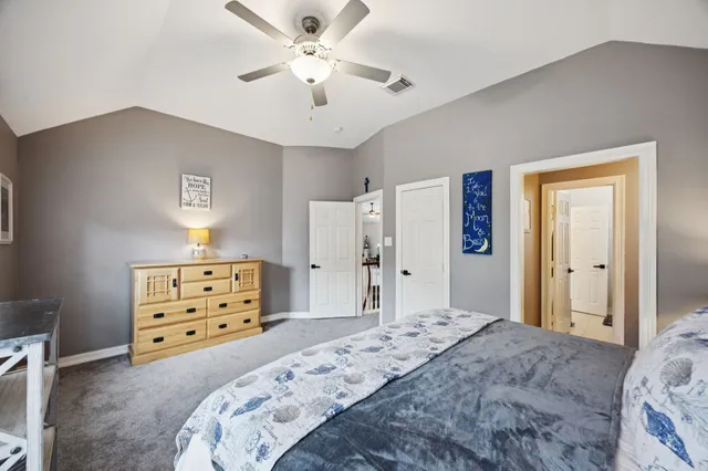 a bedroom with a bed and a dresser