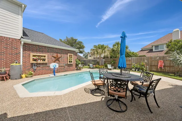 a view of a patio with couches table chairs and floor to ceiling window