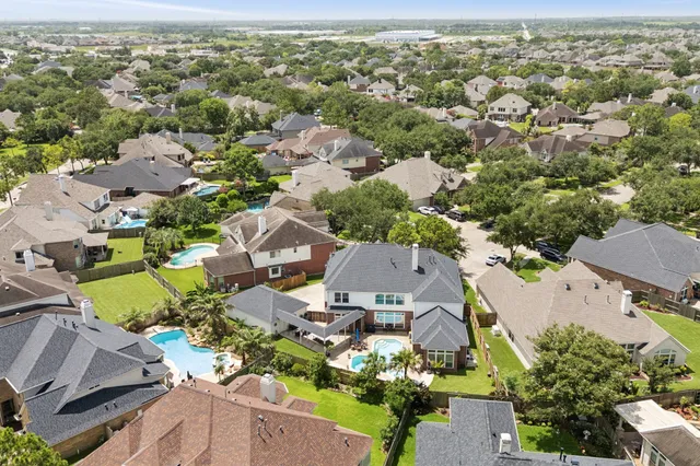 an aerial view of residential houses with outdoor space