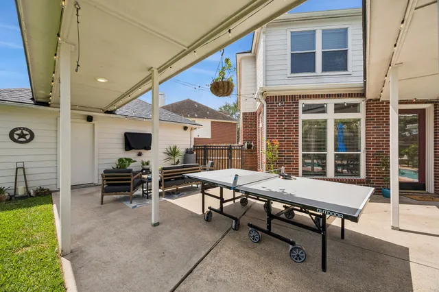 a view of a patio with a table and chairs