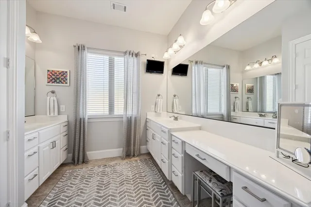 a spacious bathroom with a double vanity sink mirror and double