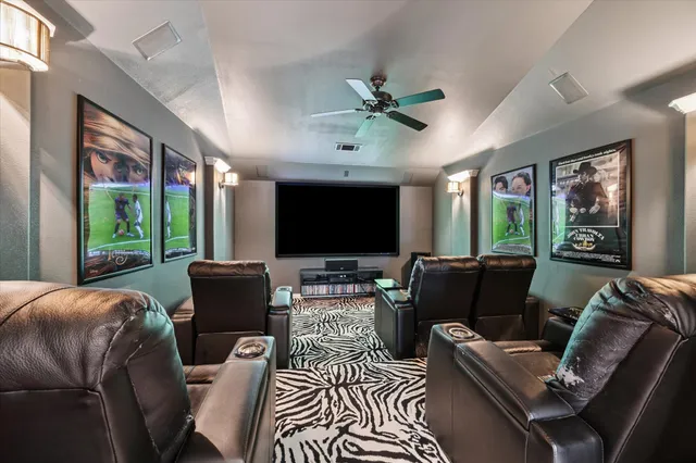 a living room with furniture a flat screen tv and a large window