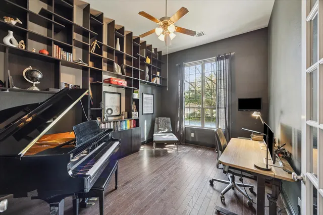 a living room with furniture gym equipment and a window