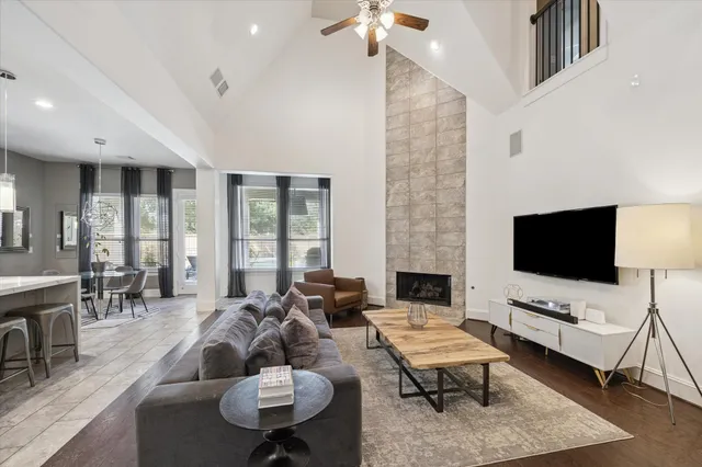 a living room with furniture a rug and a flat screen tv