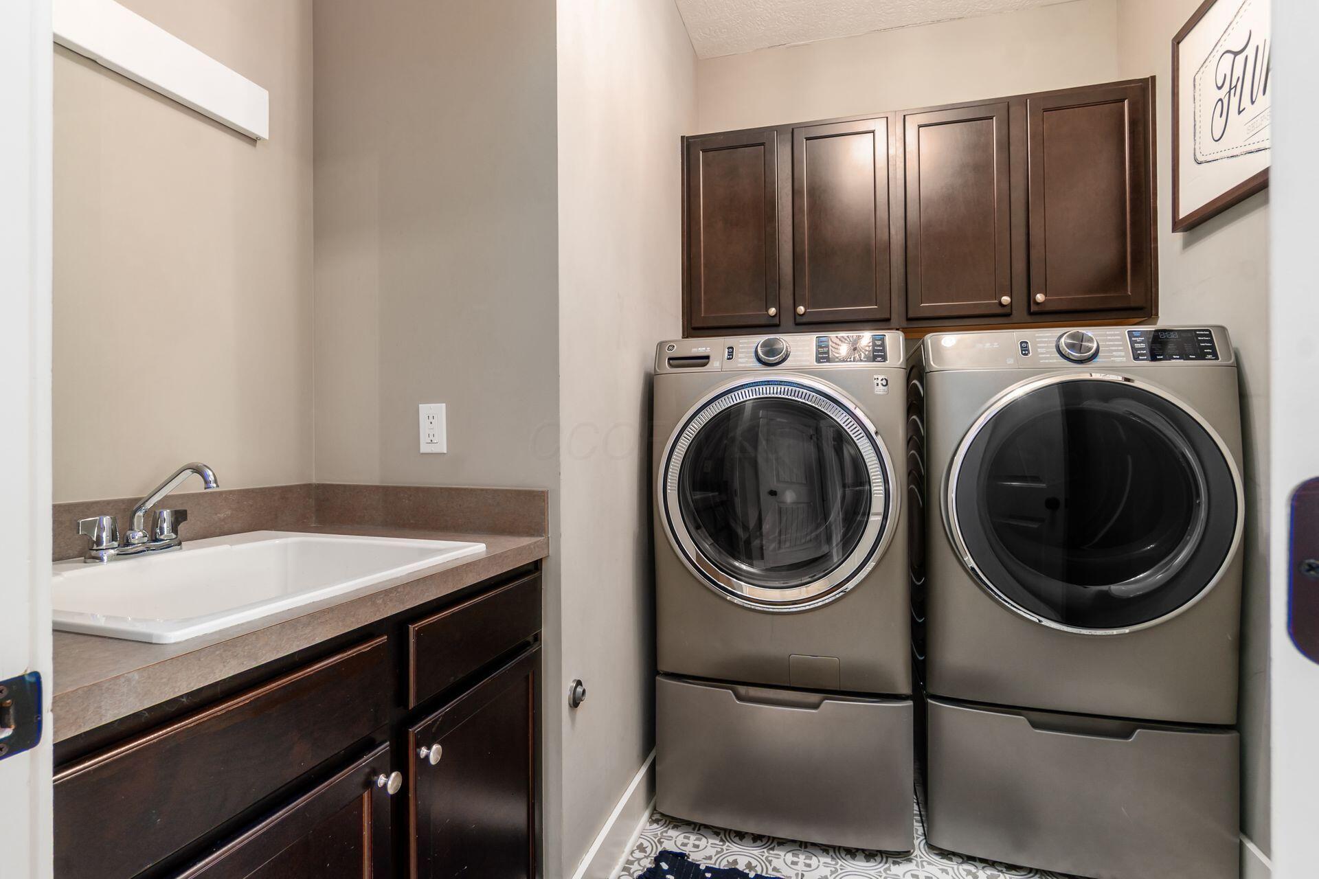 1002 Rambling Brook Way Delaware, OH 43015 - Photo 57 of 104 Convenient second floor laundry with utility sink and front load washer and dryer.