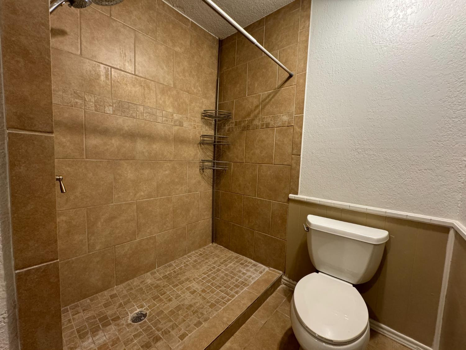 3103 75th Street, Unit B Lubbock, TX 79423 - Photo 11 of 22 a white toilet sitting next to a bathroom sink