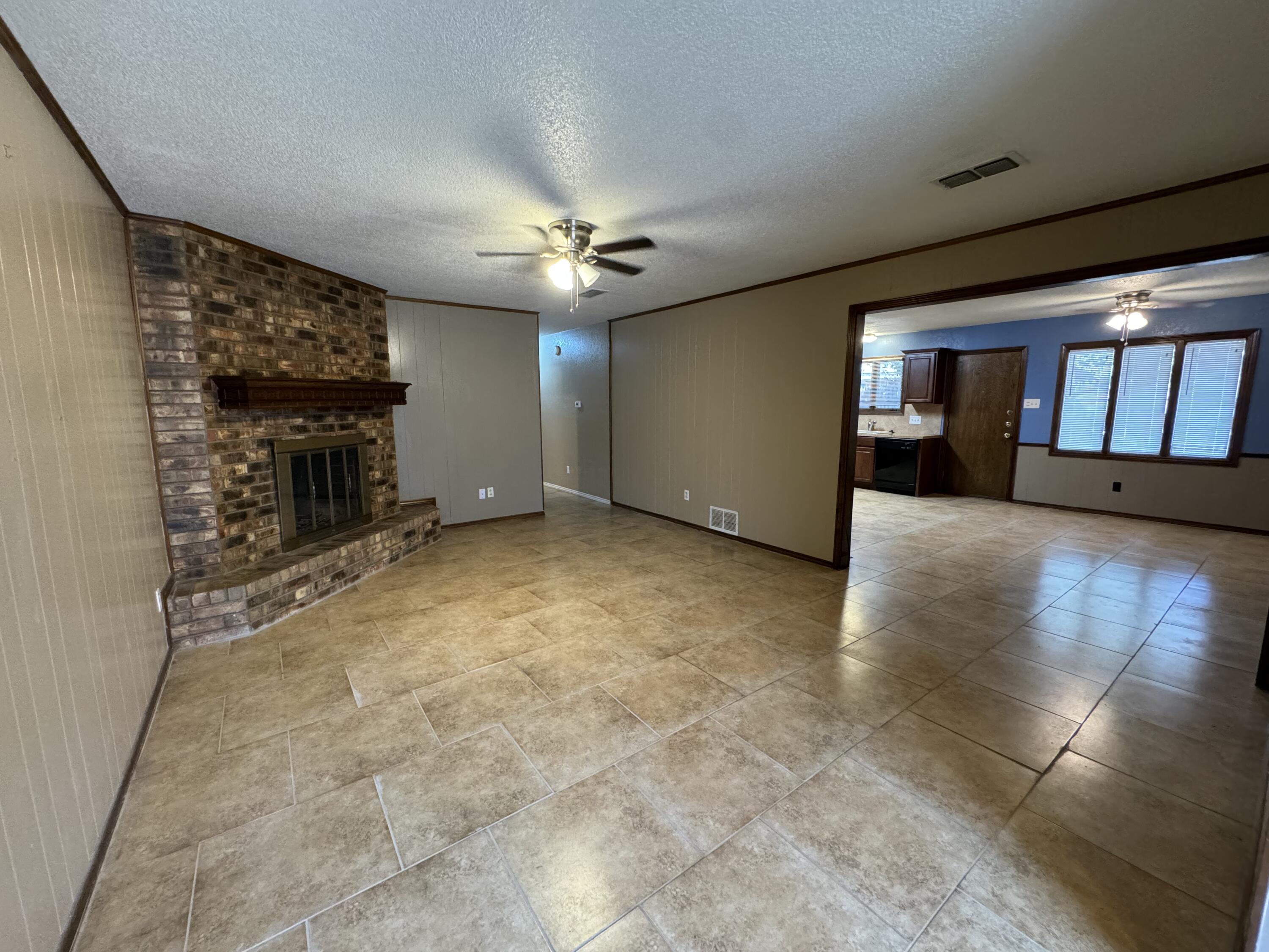 3103 75th Street, Unit B Lubbock, TX 79423 - Photo 13 of 22 en empty room with windows and a fireplace