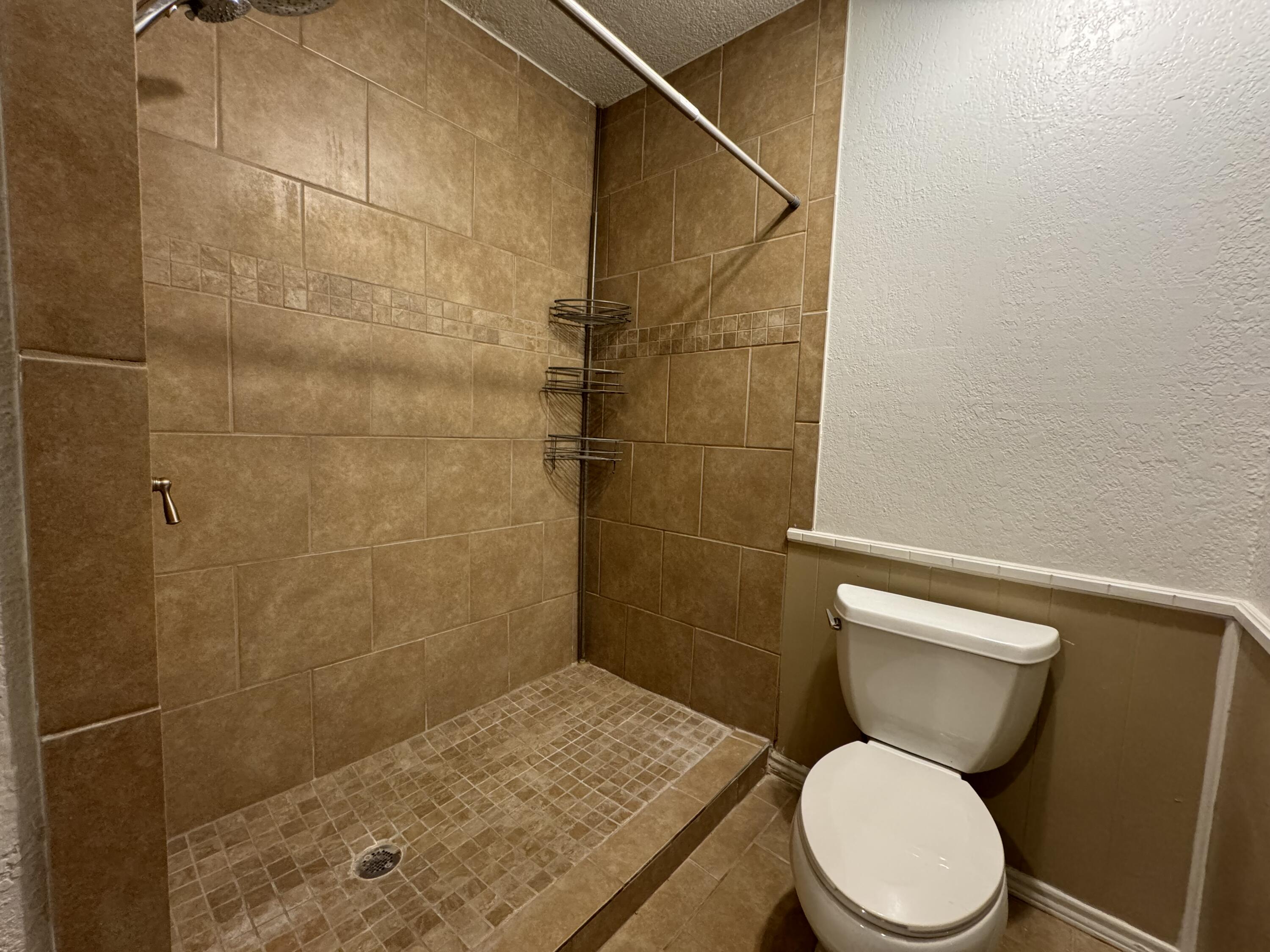 3103 75th Street, Unit B Lubbock, TX 79423 - Photo 22 of 22 a white toilet sitting next to a bathroom sink