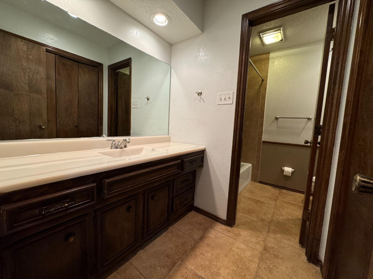 3103 75th Street, Unit B Lubbock, TX 79423 - Photo 5 of 22 a bathroom with a sink and a mirror