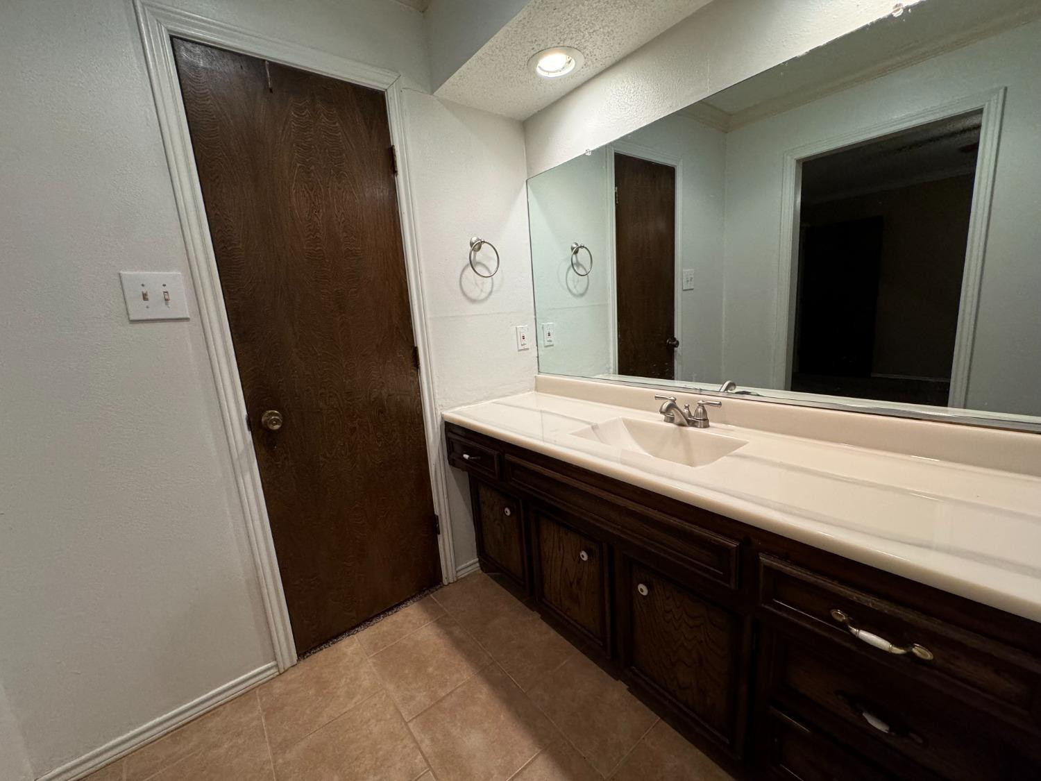 3103 75th Street, Unit B Lubbock, TX 79423 - Photo 9 of 22 a bathroom with a double vanity sink and mirror