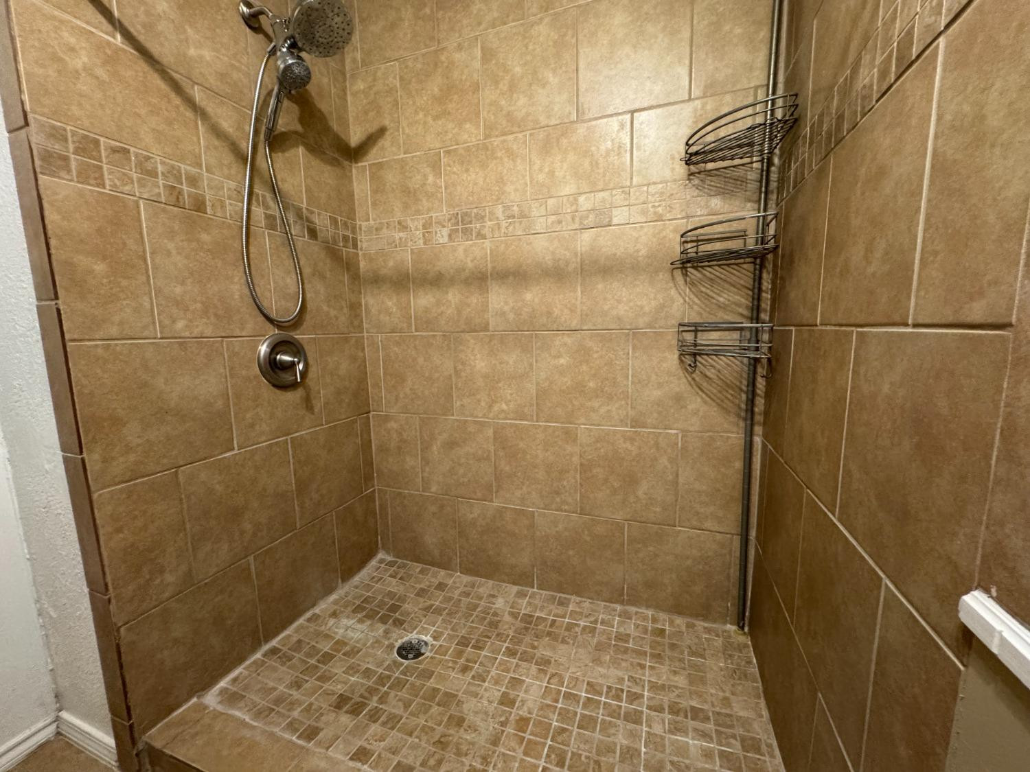 3103 75th Street, Unit B Lubbock, TX 79423 - Photo 10 of 22 a bathroom with a shower