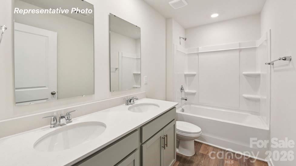 3913 Caroline Court Northwest Conover, NC 28613 - Photo 24 of 27 a bathroom with a granite countertop sink toilet and shower