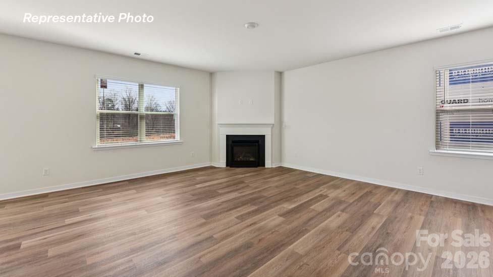3913 Caroline Court Northwest Conover, NC 28613 - Photo 4 of 27 a view of an empty room with wooden floor and a window