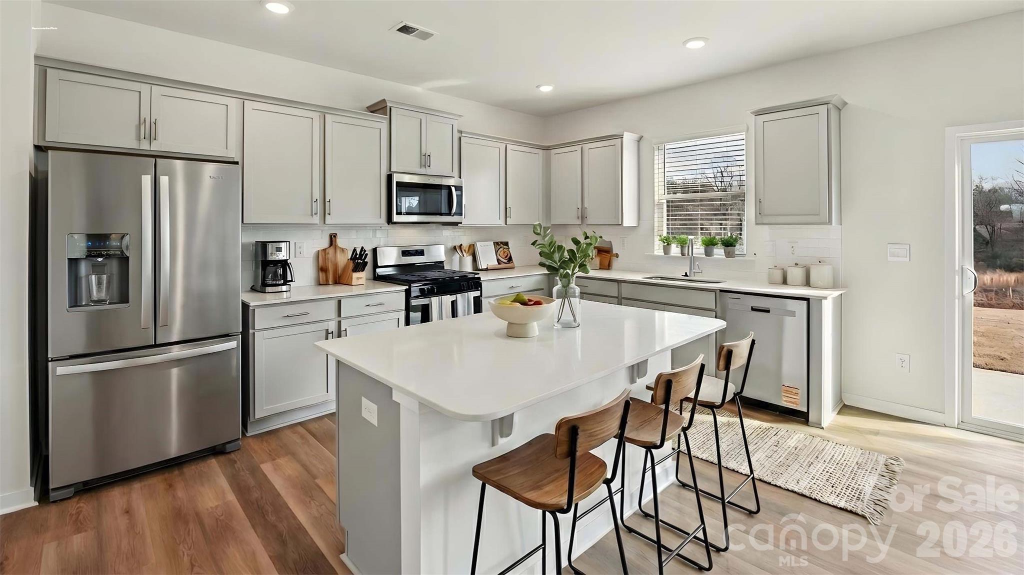 3913 Caroline Court Northwest Conover, NC 28613 - Photo 6 of 27 a kitchen with stainless steel appliances a microwave sink stove refrigerator and cabinets