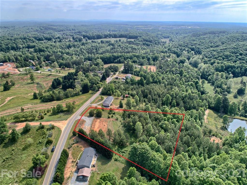 700 Will Green Road Tryon, NC 28782 - Photo 2 of 13 an aerial view of house with yard and mountain view in back