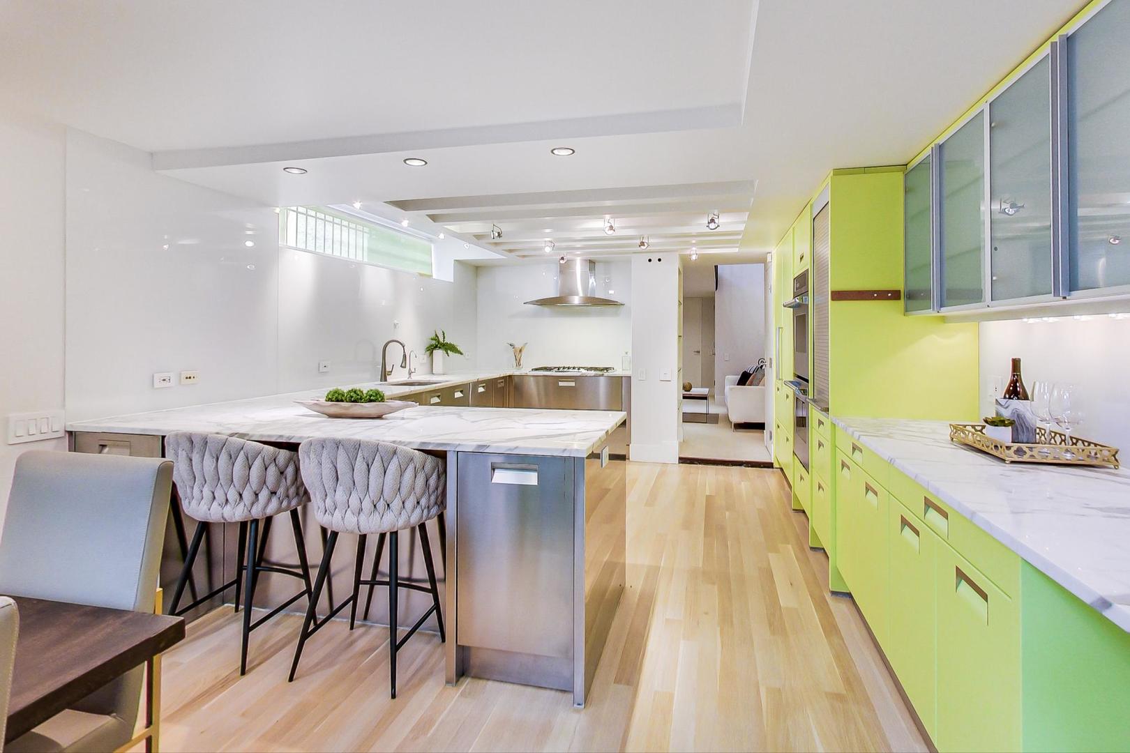 17 East Scott Street Chicago, IL 60610 - Photo 13 of 39 a kitchen with kitchen island granite countertop lots of counter top space and wooden floor