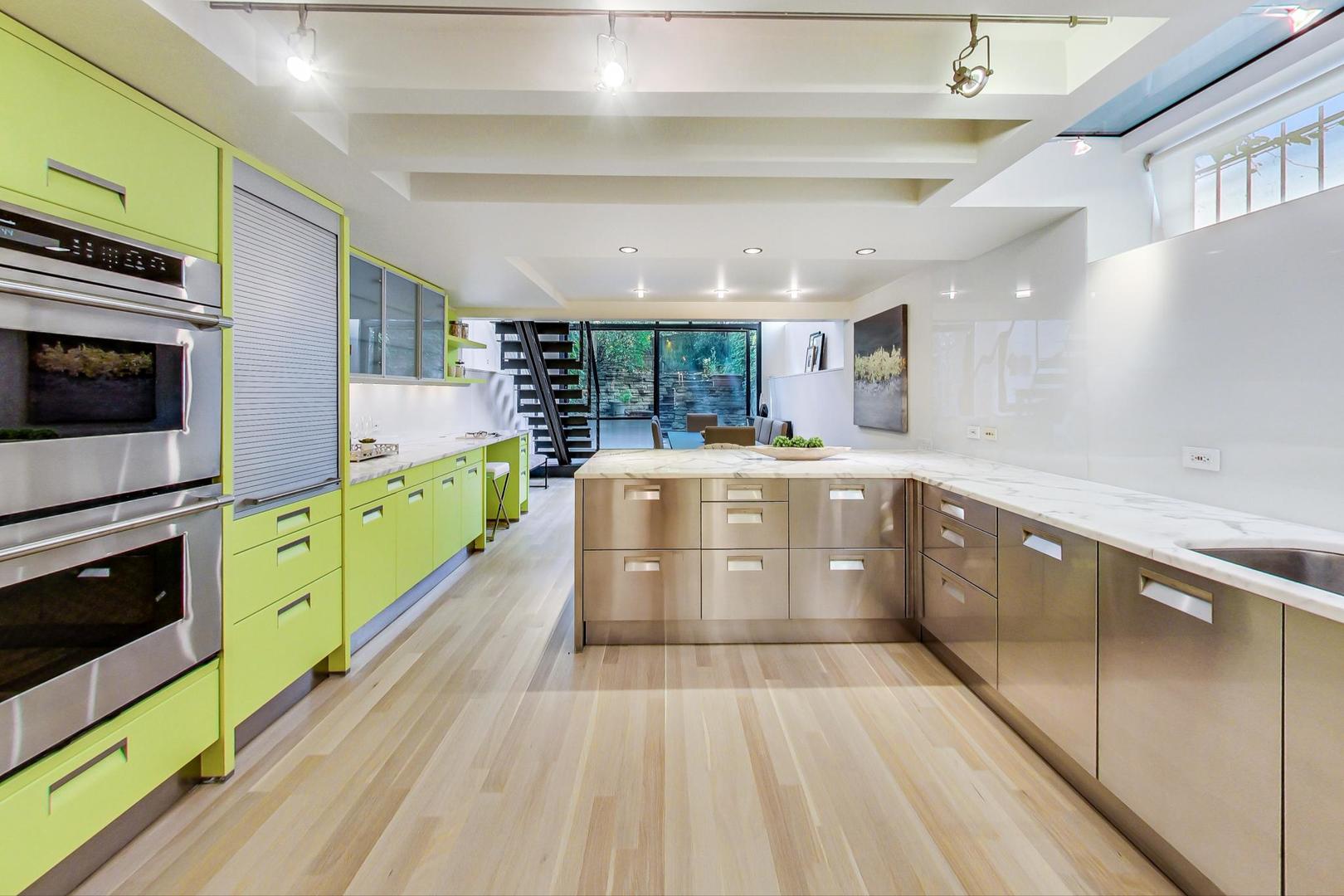 17 East Scott Street Chicago, IL 60610 - Photo 17 of 39 a kitchen with stainless steel appliances a stove a sink and a wooden floors