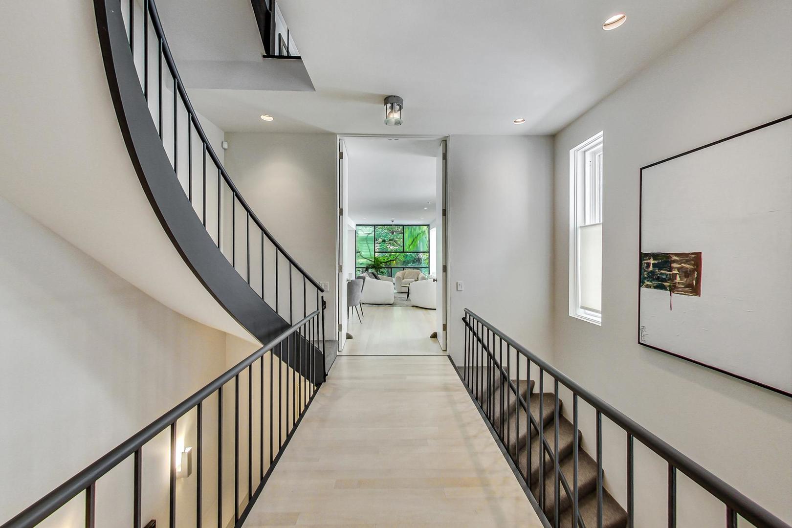 17 East Scott Street Chicago, IL 60610 - Photo 2 of 39 a view of a hallway with wooden floor and staircase