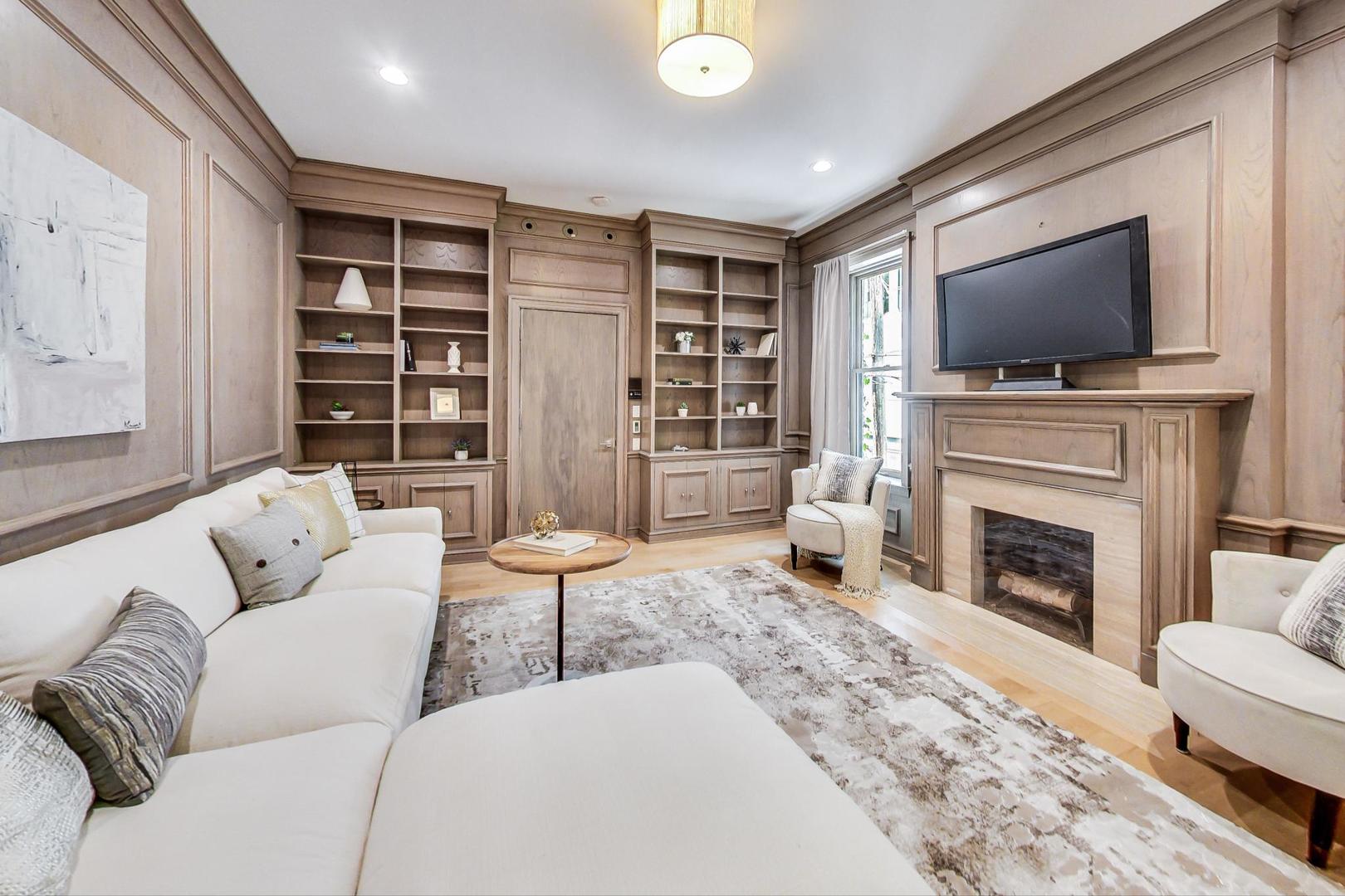 17 East Scott Street Chicago, IL 60610 - Photo 21 of 39 a living room with furniture a flat screen tv and a fireplace