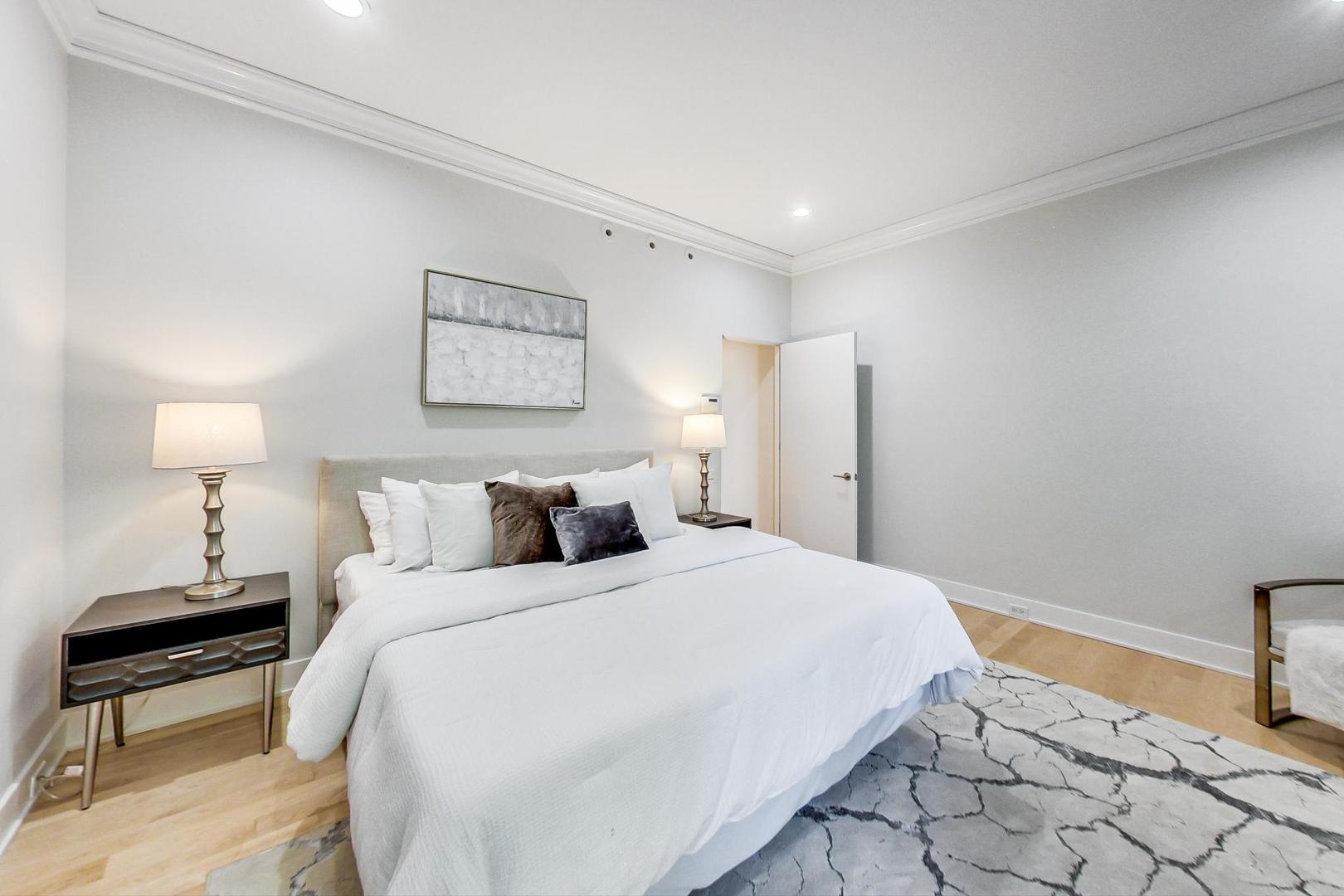 17 East Scott Street Chicago, IL 60610 - Photo 23 of 39 a bedroom with a bed and a lamp