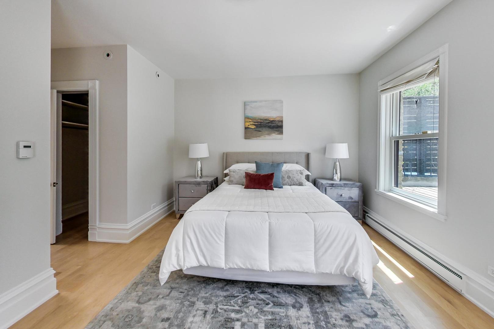 17 East Scott Street Chicago, IL 60610 - Photo 30 of 39 a bedroom with a bed and a large window