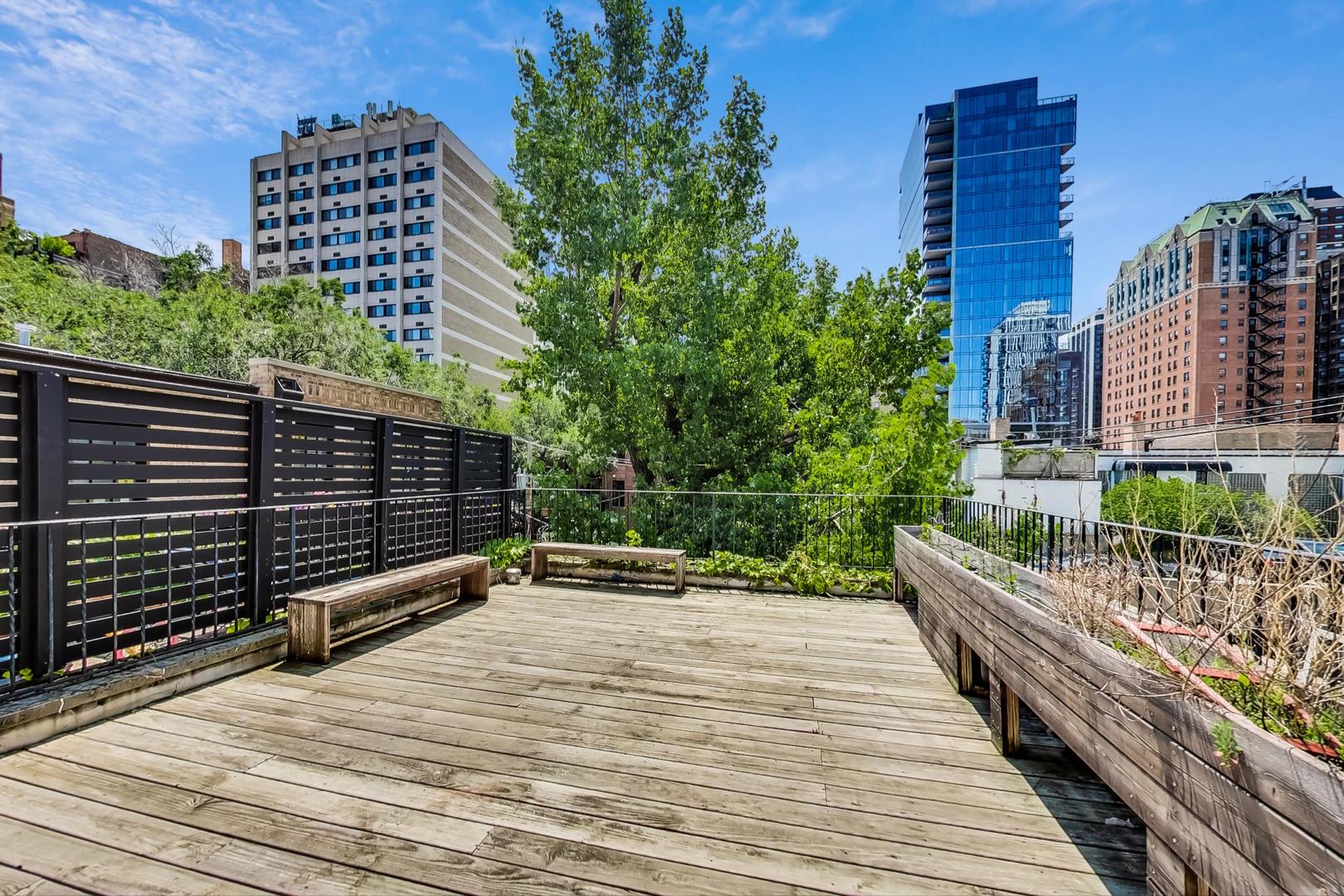 17 East Scott Street Chicago, IL 60610 - Photo 32 of 39 a view of a balcony with wooden floor and city view