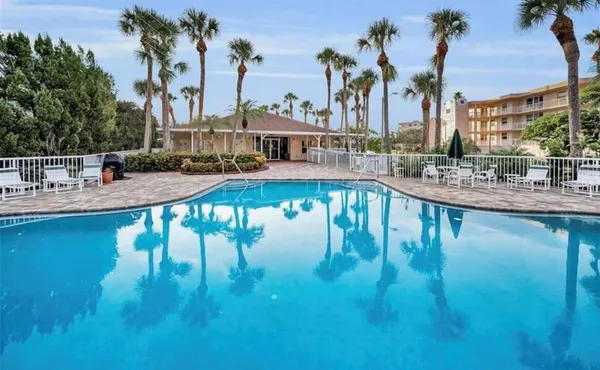 a view of swimming pool with outdoor seating and lake view