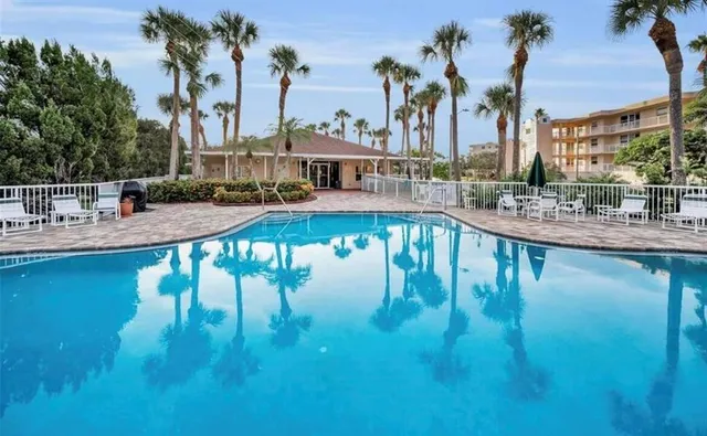 a view of swimming pool with outdoor seating and lake view