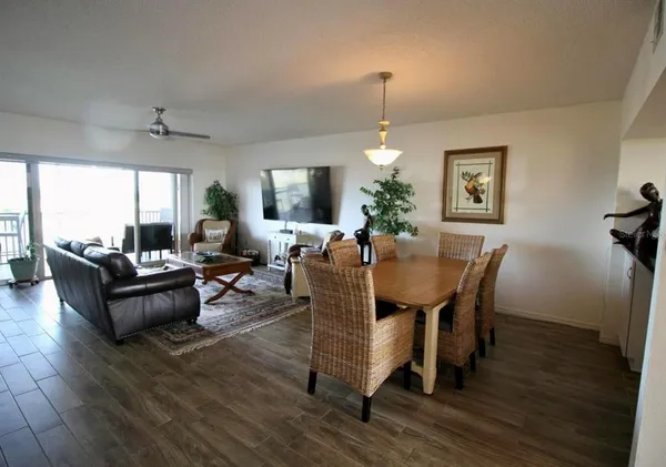 a living room with furniture dining area and a window