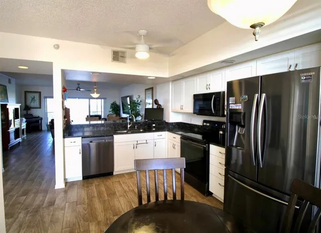 a living room with furniture wooden floor and a flat screen tv