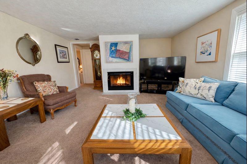 1505 Bonham Street Commerce, TX 75428 - Photo 28 of 38 Spacious secondary living room with a gas fireplace that has been changed to an electric fireplace. Fireplace virtually enchanced