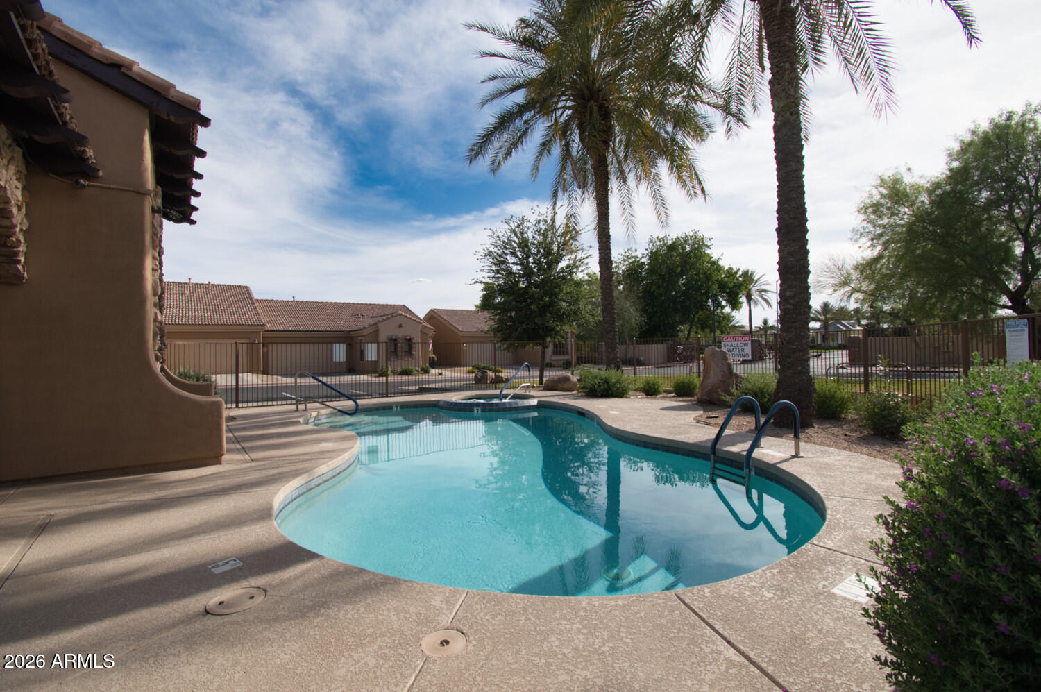2565 South Signal Butte Road, Unit 46 Mesa, AZ 85209 - Photo 40 of 41 a view of a swimming pool with a lounge chair