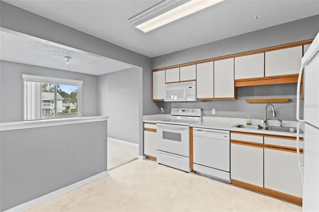 a kitchen with a sink stove and cabinets