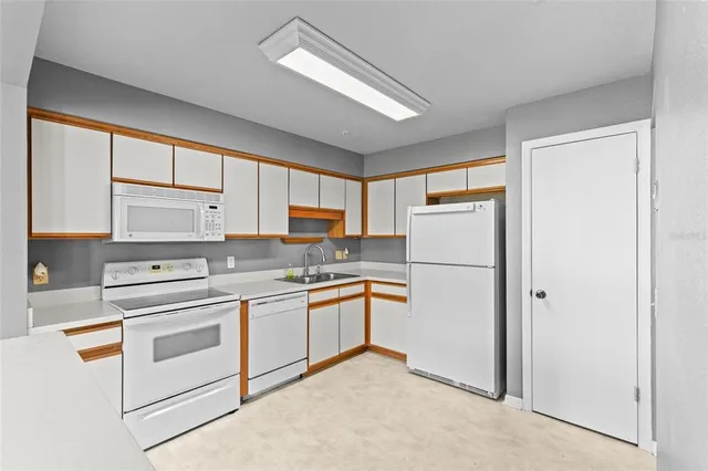 a kitchen with stainless steel appliances granite countertop a refrigerator sink and cabinets
