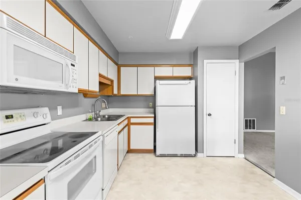 a kitchen with stainless steel appliances granite countertop a refrigerator sink and cabinets