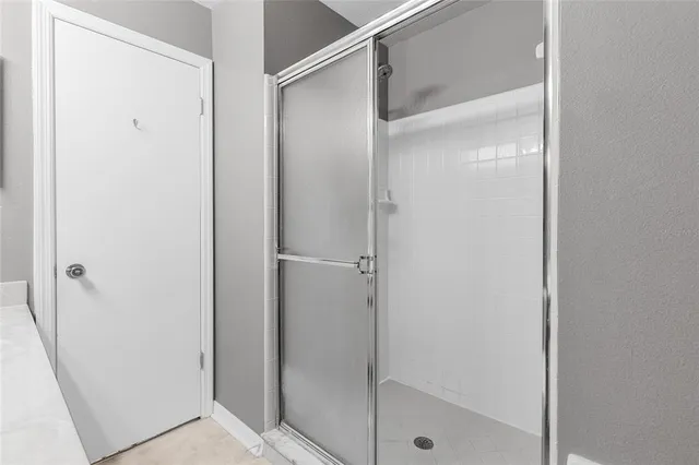 a bathroom with a glass shower door